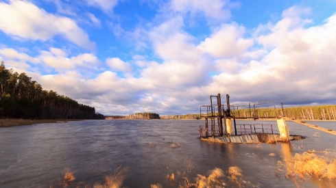 Dam on the background of clouds. Time Lapse